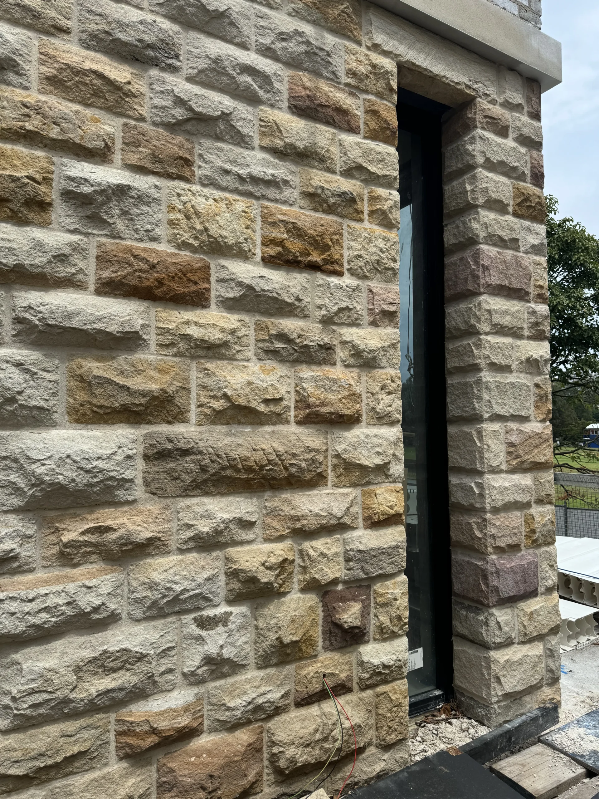 Multicolour sandstone cladding surrounding a window opening