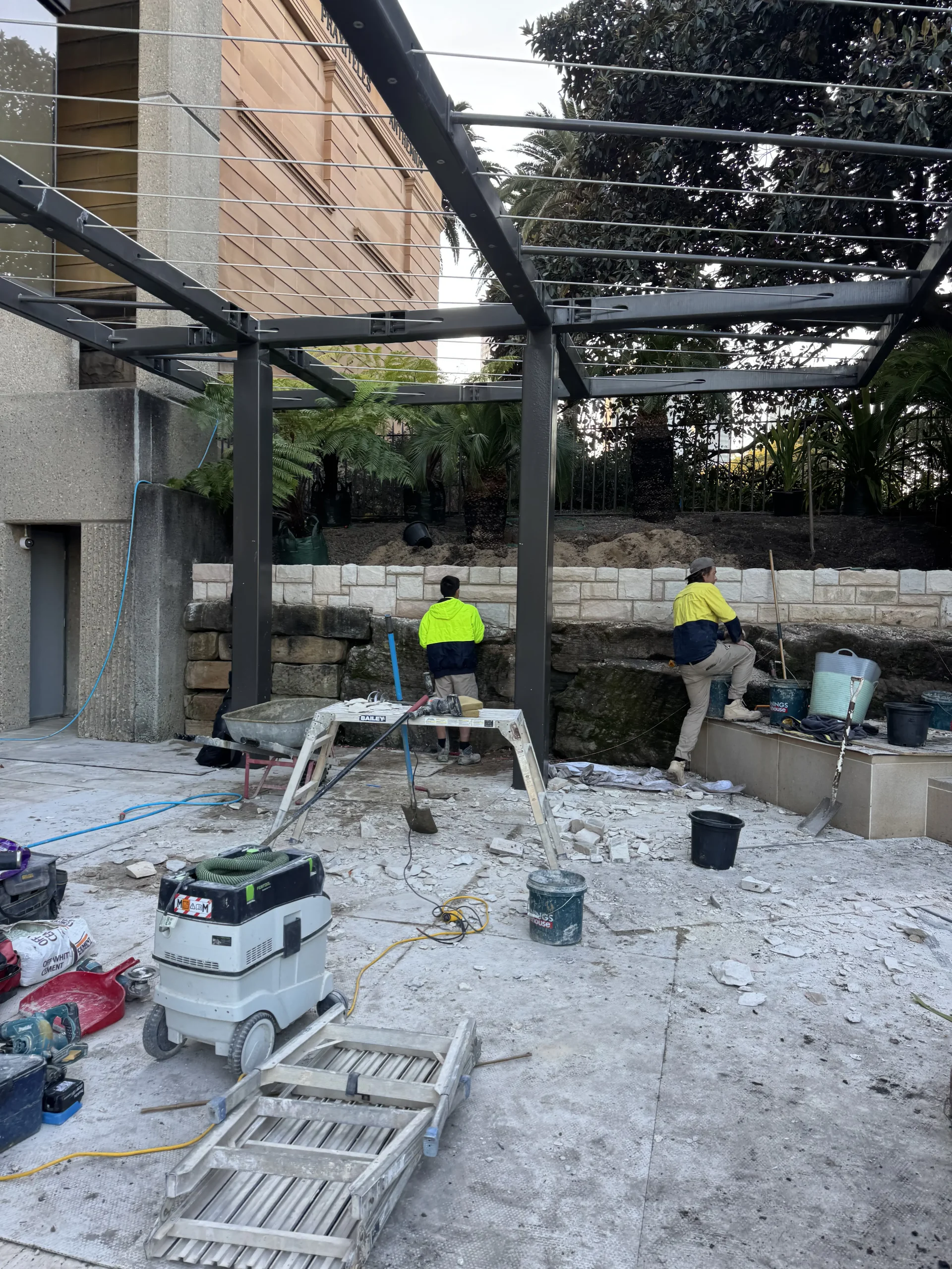 Prism Stonemasonry crew laying stone paving on site