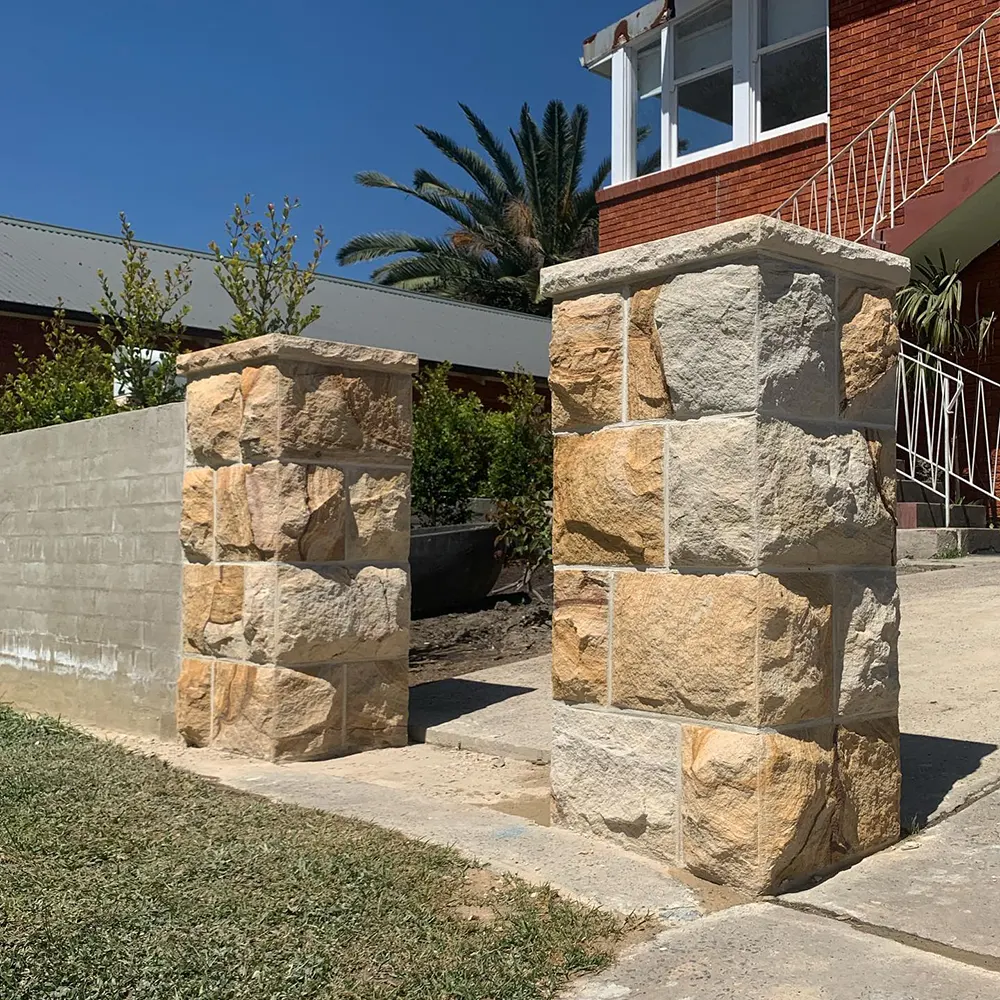 Prism Stonemasonry team completing a sandstone wall on site in Sydney