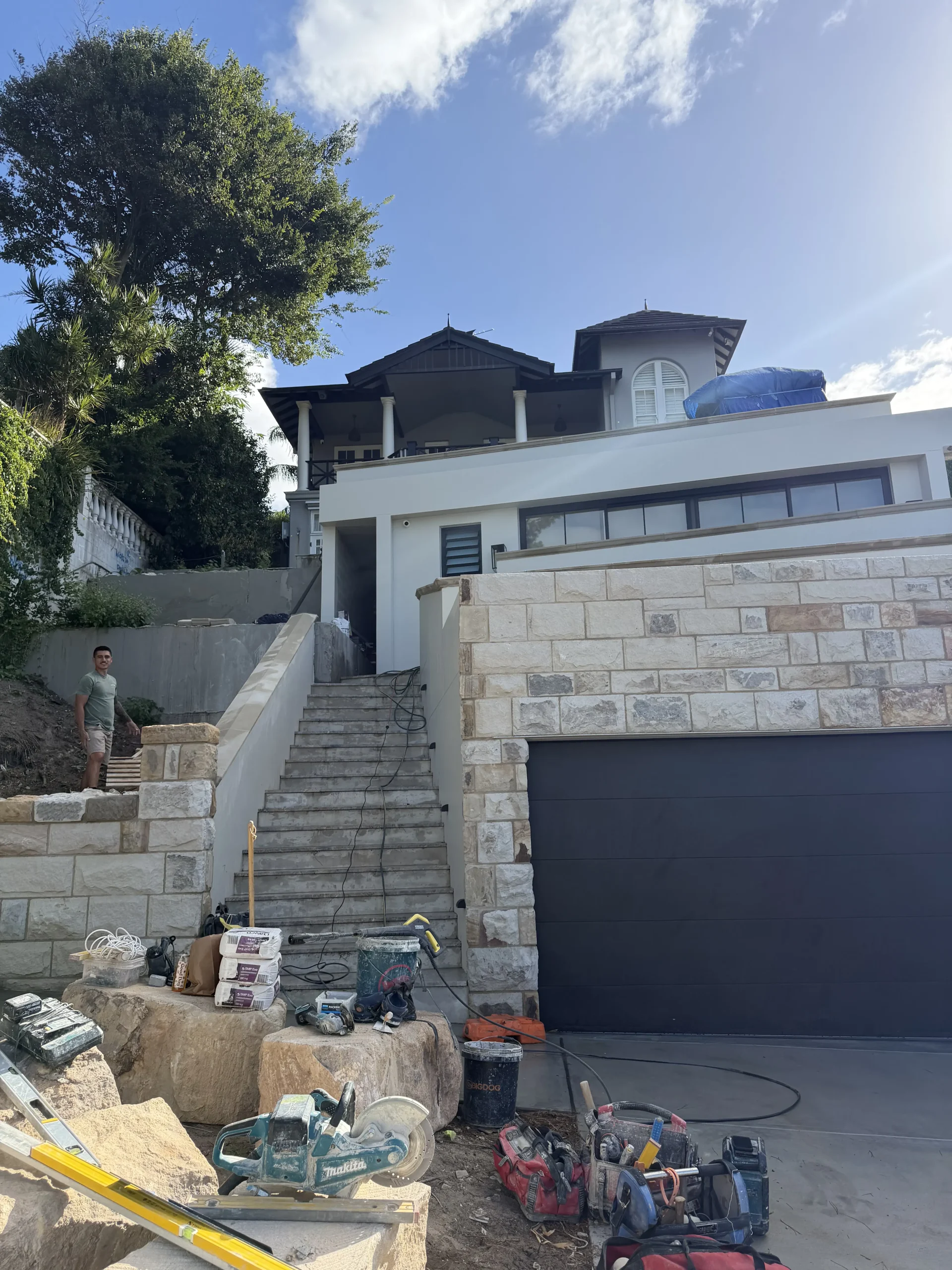 Sandstone cladding being installed on a house facade