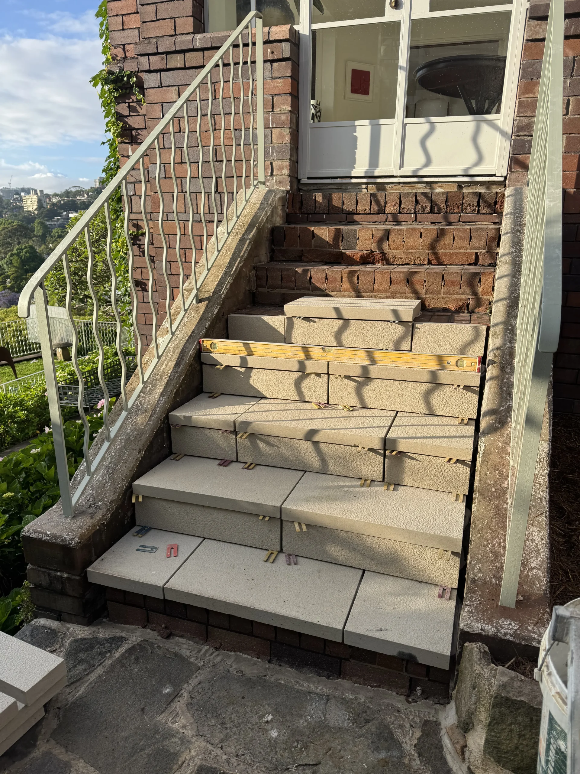 Sandstone retaining wall finished in a landscaped garden