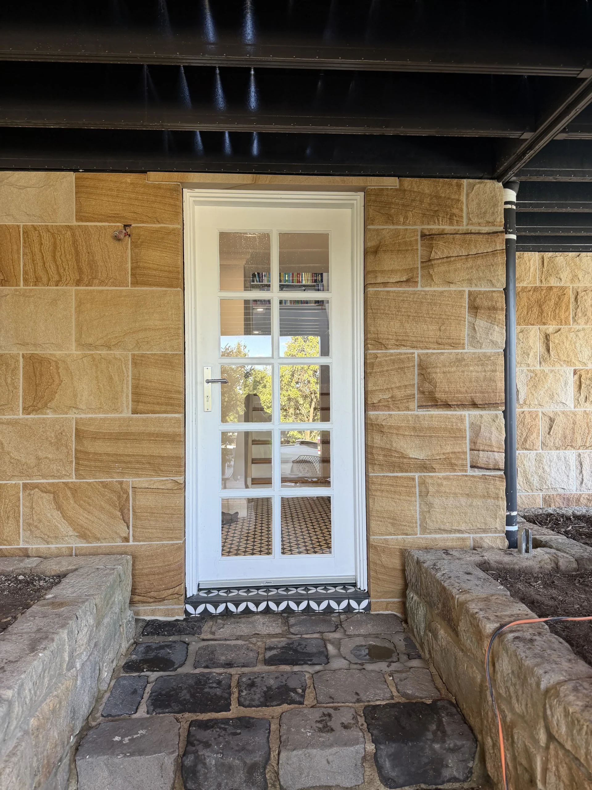 Sandstone cladding detail around a window opening