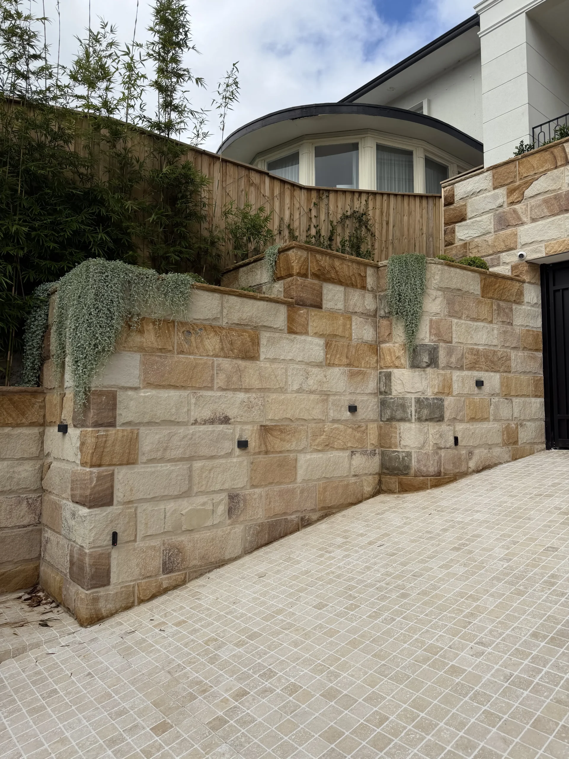 Stone-clad garden staircase beside a modern Sydney home