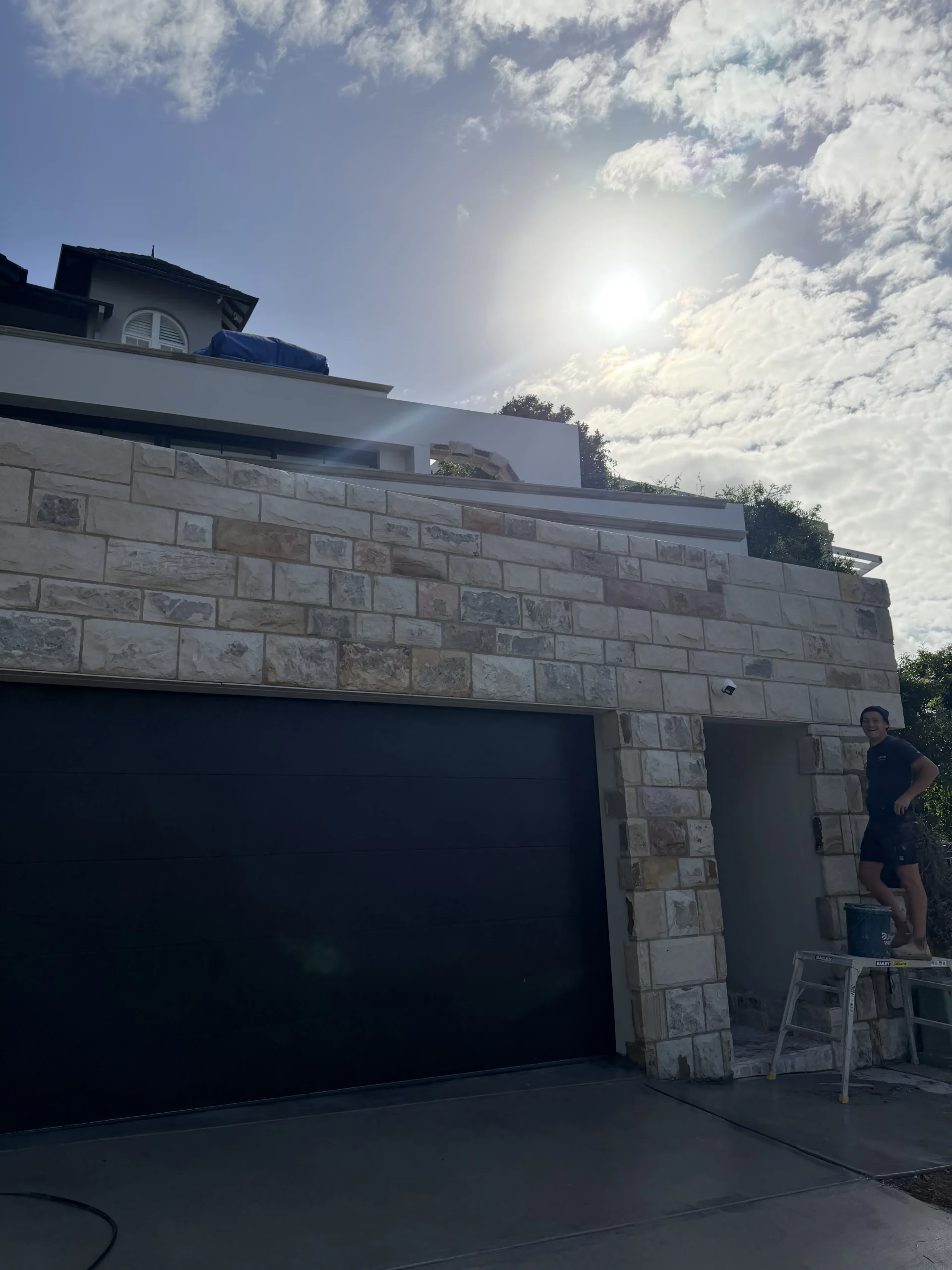 Natural stone cladding on a raised pool wall