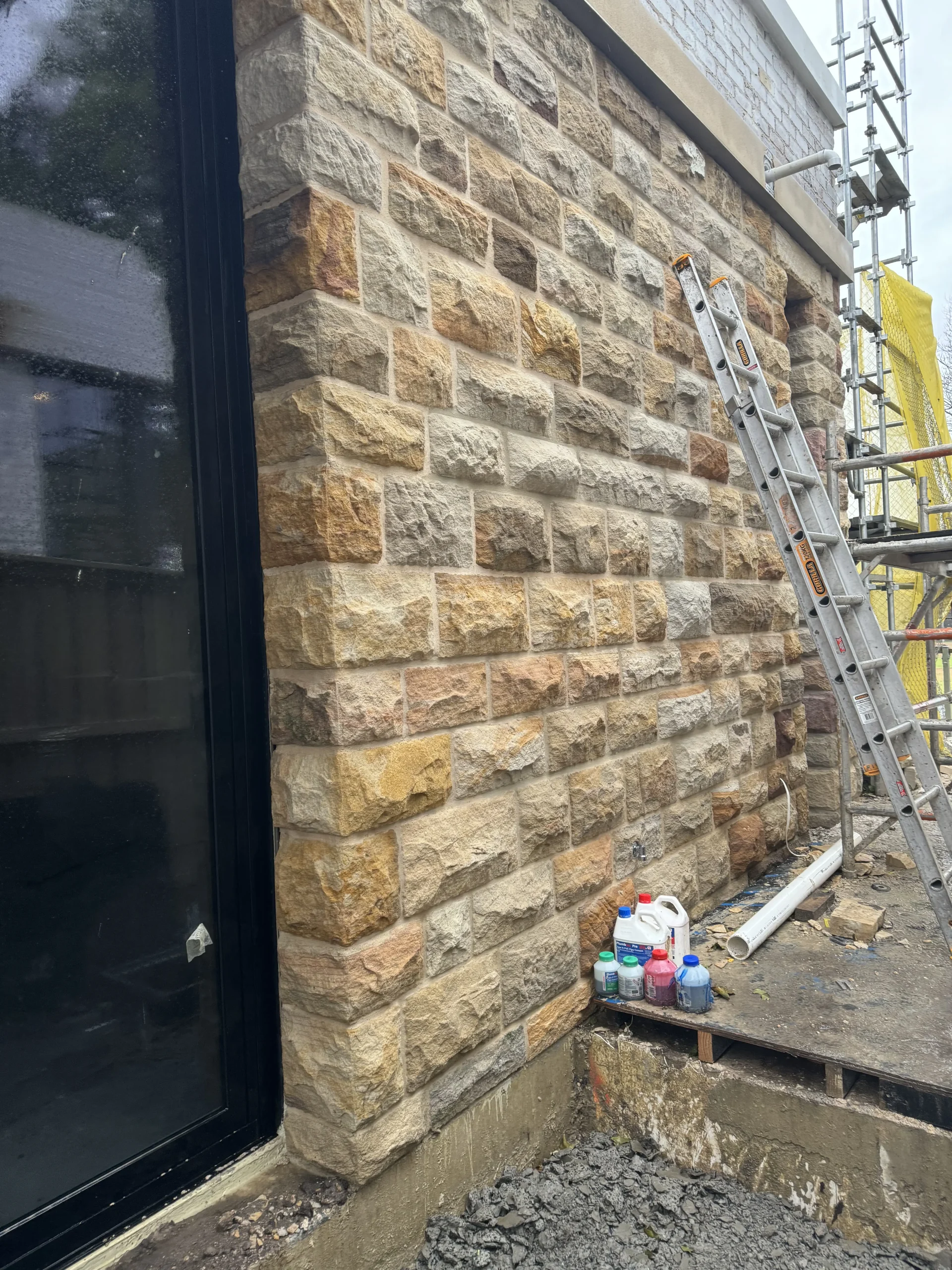 Travertine coping and paving around a modern pool